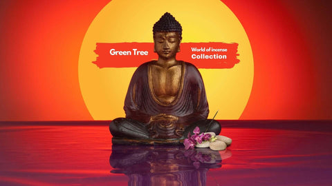 Buddha statue with flowers and stones against a vibrant sunset, showcasing Green Tree's incense collection.