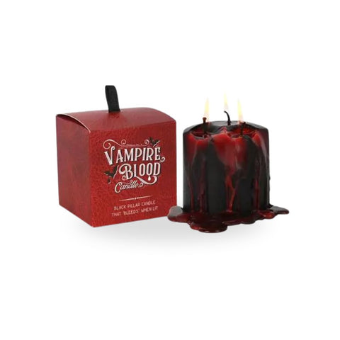 Small Vampire Blood Pillar Candle in a dramatic display with red wax dripping from black candle.