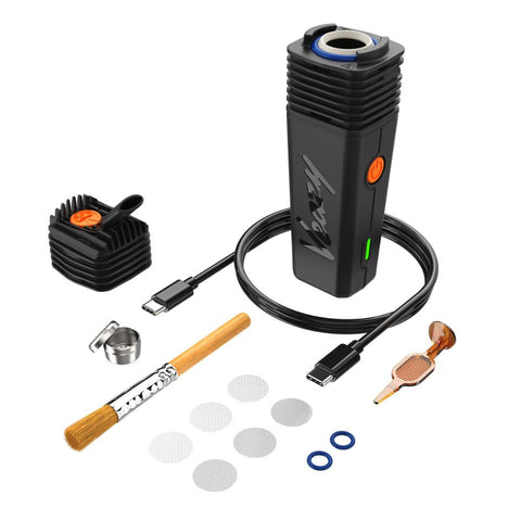 Storz & Bickel Veazy dry herb vaporizer with accessories including brush, screens, and charge cable.