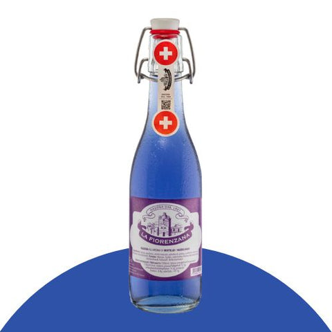 La Fiorenzana Gazosa Mirtillo in a glass bottle showcasing Swiss craftsmanship and the vibrant blue hue.